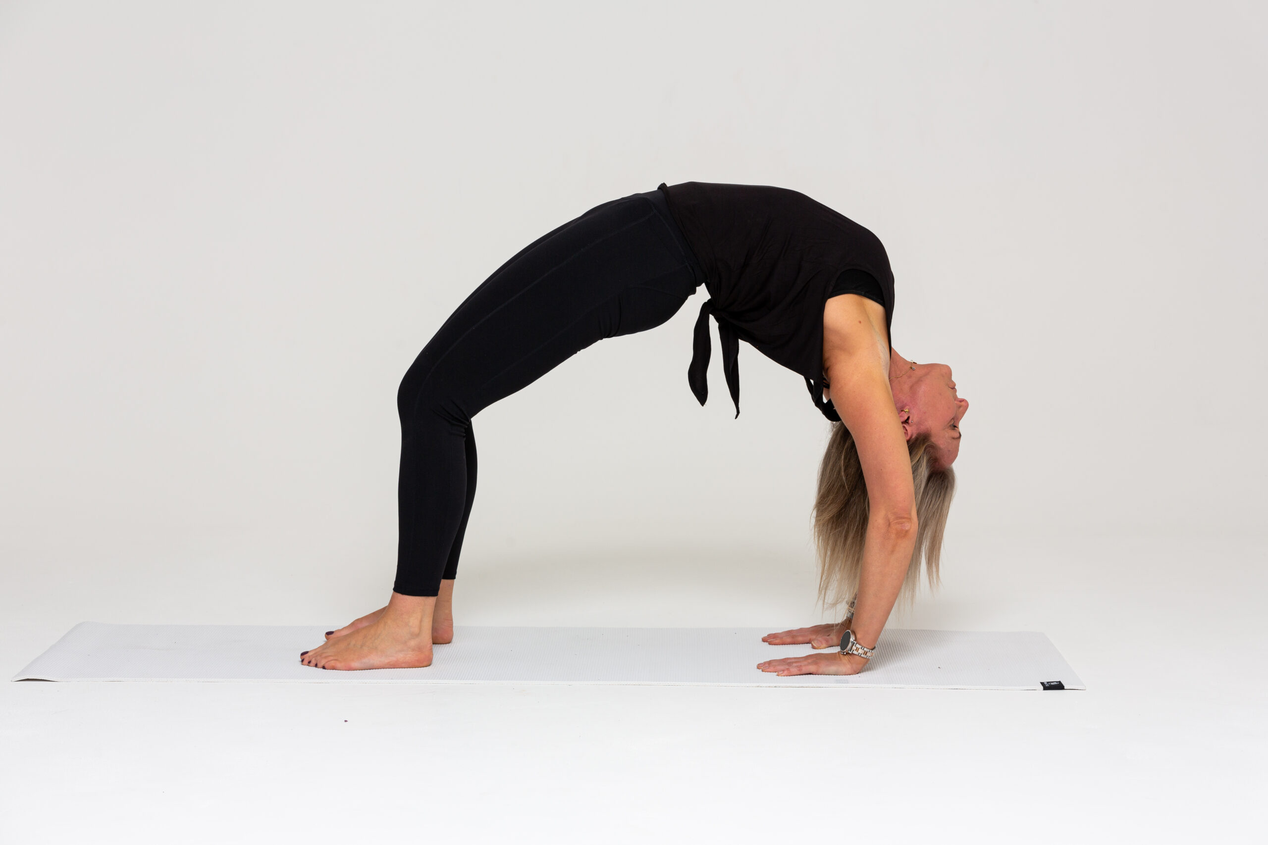Premium Photo | Beautiful sporty fit woman practices sivananmda yoga asana  anuvittasana standing back bend pose